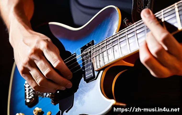 기타 중급자 연주 기술 - A detailed close-up of a skilled guitarist&rsquo;s left hand performing a smooth slide technique on an ele...